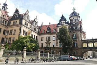 Gebäudekomplex mit Turm, gelb und beige gestrichen